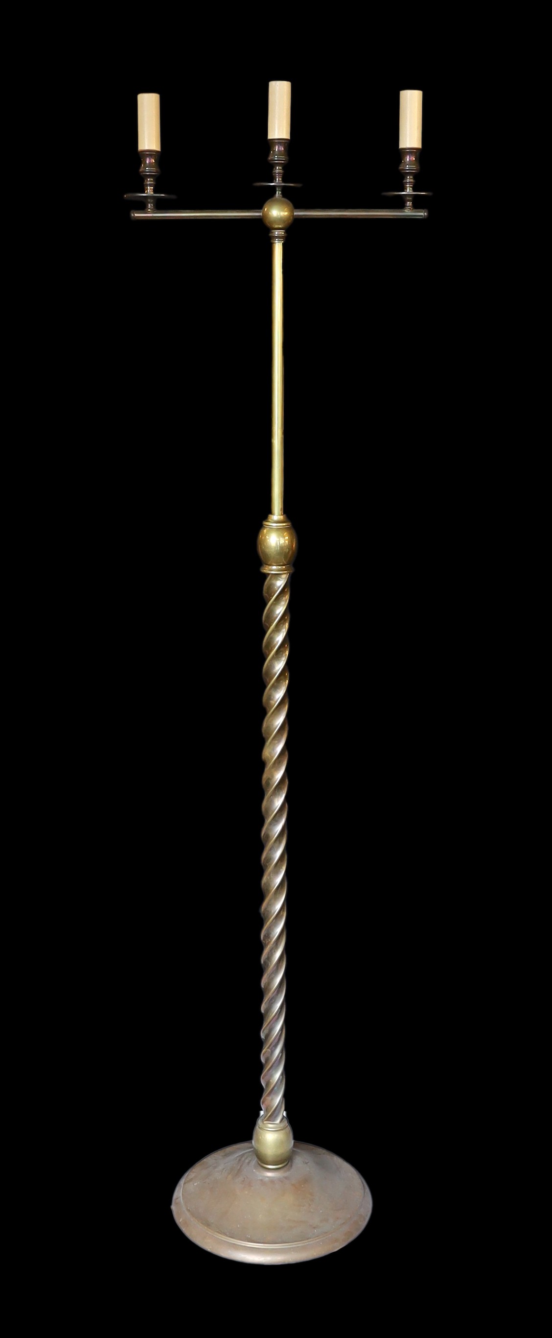 A lacquered brass three light lamp standard, with spiral fluted column and simulated candlestick sconces, height 172cm